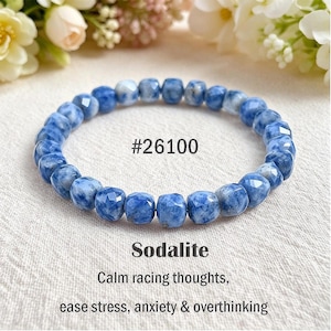 May include: A circular bracelet composed of faceted blue and white sodalite beads. The text #26100, Sodalite, and the phrase Calm racing thoughts, ease stress, anxiety & overthinking are printed in black text above and below the bracelet.