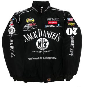 May include: Black zip-up jacket with the Jack Daniel's logo and sponsor patches. The jacket has the text "Pace Yourself. Dr Ink Responsibly." and the number "20" on the sleeve.