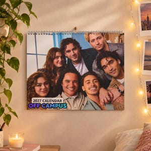 May include: A 2027 Off Campus wall calendar featuring a group portrait of six young adults. The calendar is spiral-bound at the top and displays the text 2027 CALENDAR OFF CAMPUS in the lower left corner over a blue and white background.