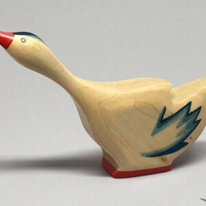 Toy Goose Wooden - with the head up and blue wings Size: 11,0 x 3,5 x 2,2 cm (b x h x s)  approx. 28,0  gr.