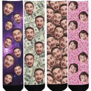 May include: Four pairs of socks with unique designs. One pair features a galaxy background with smiling faces. Another pair has a dollar bill design. The third pair has a repeating pattern of smiling faces. The last pair has a pink leopard print with smiling faces.