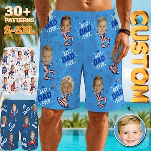 May include: Blue custom swim trunks with a repeating pattern of children's faces, fireworks, and the text "BEST DAD EVER." Additional shorts in white and blue with similar designs are also shown. The shorts are available in sizes S-5XL.