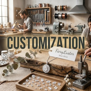 May include: A silver-toned necklace with an oval-cut center stone surrounded by a halo of smaller stones, resting on a wooden surface with a tag labeled FieryLuster Etsy Shop, alongside a wooden tray filled with various loose gemstones.