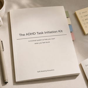 May include: A cream-coloured notebook titled "The ADHD Task Initiation Kit" with a pen, sticky notes, and a mug of coffee. The notebook has colourful page markers and the text "A minimal system to help you start when you feel stuck."