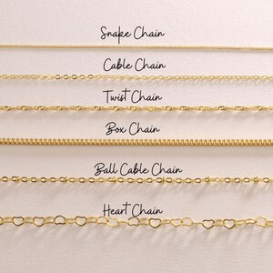 May include: A selection of gold-colored chain necklaces, each with a unique design. The image displays six different chain styles: Snake, Cable, Twist, Box, Ball Cable, and Heart chains. The names of each chain style are written above the chain.