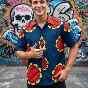May include: A short-sleeved button-down shirt in dark blue featuring a repeating pattern of large sunflowers with red centers and yellow petals. The shirt has a classic collar, a single chest pocket, and a button-front closure design.