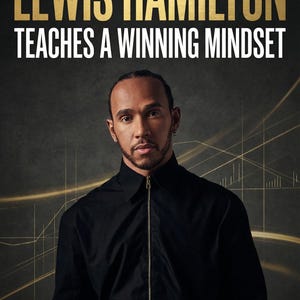 May include: Image features Lewis Hamilton with the text "LEWIS HAMILTON TEACHES A WINNING MINDSET" in gold and white. Hamilton is wearing a black zip-up shirt against a dark background with gold lines.