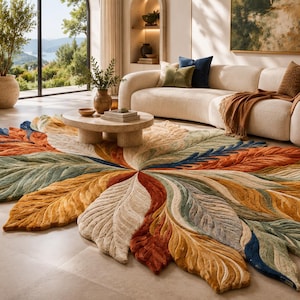 May include: A large, oval-shaped area rug featuring a radial pattern of textured, leaf-like segments in shades of burnt orange, mustard yellow, sage green, cream, and deep navy blue, with a thick, tufted pile construction and defined veins.