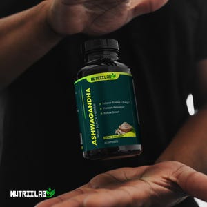 May include: A bottle of Nutriilab Ashwagandha with Black Pepper dietary supplement. The bottle is dark with a green and yellow label. Text on the label includes "Enhance Stamina & Energy", "Promotes Relaxation", and "Reduce Stress". The bottle contains 60 capsules.
