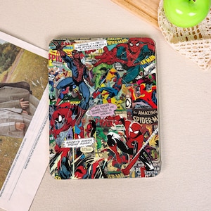 May include: A rectangular tablet case featuring a vibrant collage of vintage Spider-Man comic book panels. The design includes multiple illustrations of the character in red and blue costumes, along with speech bubbles containing text like "My spider sense tells me something is wrong" and "Spidey's gonna strike again."