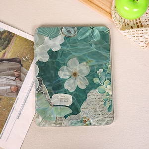 May include: A rectangular tablet case featuring a collage design with a teal water surface background, a large white flower, a green moth, a compass, and script text. A small white label on the case displays the text, Love you to the moon and back.