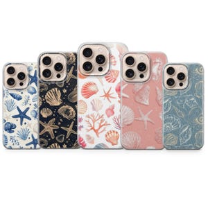 May include: Five phone cases with ocean-themed designs. The cases feature various patterns including seashells, starfish, and coral in shades of blue, black, pink, and white. The cases are designed to fit a smartphone and have a clear border.