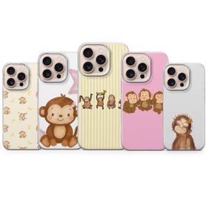 May include: A collection of five phone cases featuring adorable monkey designs. The cases showcase various patterns, including monkeys with bananas, a cute monkey with a flower, and a group of monkeys. The color palette includes pink, yellow, and white.