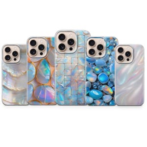 May include: Five phone cases with iridescent designs. The cases feature various patterns, including a mother-of-pearl effect, mosaic tiles, and gemstone-like textures. Each case has a clear border around the camera.