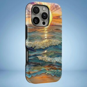 May include: A phone case featuring a sunset over the ocean. The design has a mosaic-like appearance with shades of orange, yellow, blue, and white. The case has a black border and a glossy finish.