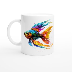 May include: White ceramic mug featuring a vibrant watercolor illustration of a colorful fish. The fish has blue, orange, yellow, and purple hues, with long flowing fins. The mug has a curved handle and a glossy finish.