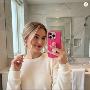 May include: A set of three ceramic canisters with lids. The canisters are white with a blue floral pattern. The largest canister is 8 inches tall, the medium is 7 inches, and the smallest is 6 inches.