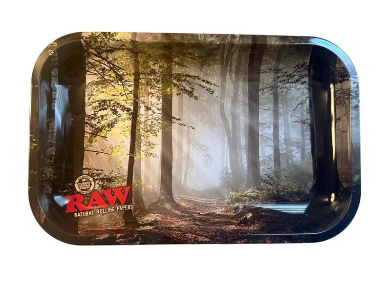 May include: Rectangular metal rolling tray with a forest scene. The tray features a path through a misty forest with tall trees and sunlight. The RAW logo is in red and white in the lower left corner.