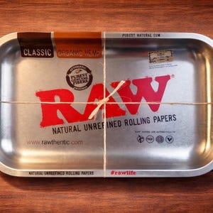 May include: A set of three ceramic mugs with a speckled, matte finish. The mugs are in cream, light grey, and dark grey. Each mug has a simple, minimalist design, ideal for coffee or tea.