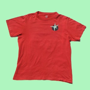 May include: A set of three ceramic mugs with a speckled, matte finish. Each mug is a different colour: light blue, cream, and grey. The mugs have a simple, modern design with a rounded shape and a handle.