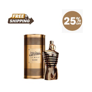 May include: A gold-toned perfume bottle and matching cylindrical container. The bottle is shaped like a torso with black stripes. The container has the text "Jean Paul Gaultier LE MALE ELIXIR".