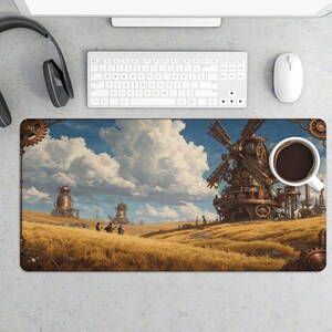 May include: A rectangular desk mat featuring a steampunk landscape with a windmill, buildings, and figures in a field of wheat under a cloudy sky. A white coffee cup sits on the mat, next to a keyboard and mouse.