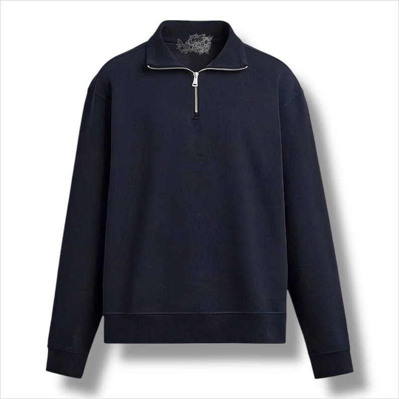 May include: Navy blue sweatshirt with a quarter-zip fastening and a collared neckline. The long-sleeved top has a ribbed hem and cuffs. A small graphic is visible on the upper back of the collar.