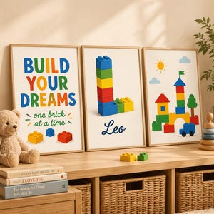 May include: Three framed wall art prints featuring colourful plastic building blocks. The first print says BUILD YOUR DREAMS one brick at a time. The second print shows a letter L made of blocks and the name Leo. The third print depicts a block castle.