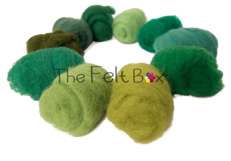 May include: A collection of ten different shades of green wool roving, arranged in a circle. The wool is soft and fluffy, and the colors range from light green to dark green.