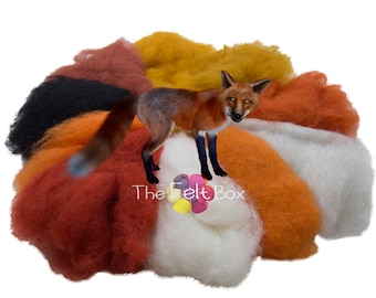 May include: A set of wool roving in various shades of orange, red, yellow, white, and black. The roving is arranged in a circle around a small, red fox figurine. The text "The Felt Box" is visible in the center of the image.