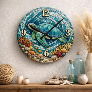 May include: Round wall clock featuring a sea turtle design. The clock face has a mosaic tile background in shades of blue, with gold numerals. The clock hands are black, and the design includes coral, seashells, and a starfish.