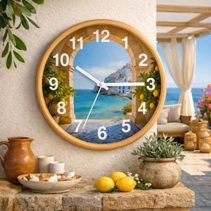 May include: A round wall clock with a light wood frame. The clock face features a scenic view of a coastal town with blue water and white buildings. The clock hands are white, and the numbers are black.