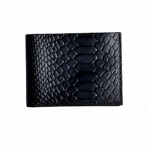 May include: Black leather wallet with a reptile skin texture. The wallet is rectangular and has a bi-fold design. The surface has a scale-like pattern, creating a textured appearance. The wallet is a solid black color.