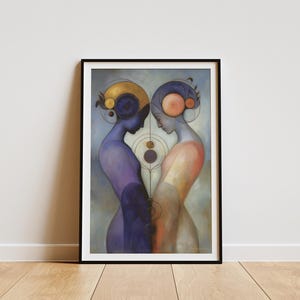 May include: Framed art print featuring two stylized figures facing each other. One figure is in shades of purple, the other in peach. Both have elaborate headpieces with geometric designs. The artwork is set against a muted blue-gray background.
