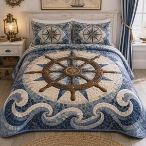 May include: A bedding set featuring a large brown ship's wheel centred on a quilt with a blue and cream mosaic-style pattern of ocean waves and a compass rose. The set includes two matching pillow shams with a central compass rose design.