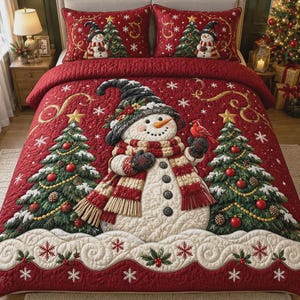May include: A red quilted bedspread and two matching pillow shams featuring a large central snowman wearing a dark hat and striped scarf, flanked by two decorated Christmas trees, with a pattern of white snowflakes and holly berries throughout.