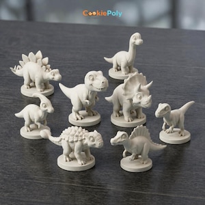 May include: A collection of eight off-white dinosaur figurines, each on a circular base. The dinosaurs include a Stegosaurus, a Tyrannosaurus Rex, a Triceratops, and others. The CookiePoly logo is in the top left corner.