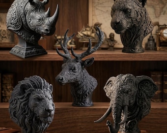 May include: Five black animal busts featuring intricate carved patterns, including a rhinoceros, a leopard, a deer with antlers, a lion with a full mane, and an elephant with tusks, all displayed on a wooden shelf with a pen in the foreground.