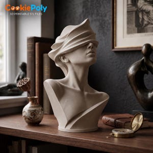 May include: A beige sculpture of a human bust with eyes covered by draped fabric. The figure has a smooth, matte finish and is positioned in a neutral pose with the head tilted slightly upward, showcasing detailed facial features and neck structure.