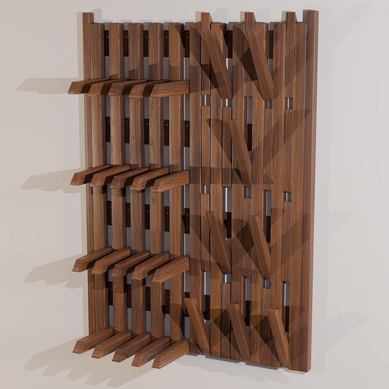 May include: A wall-mounted wooden rack featuring a series of vertical slats and multiple horizontal pegs extending outward. The structure is crafted from dark brown wood with a visible grain pattern, designed for organizing items on a flat surface.
