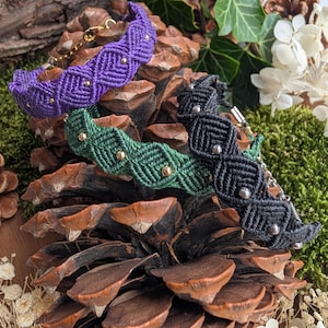 May include: Three macrame bracelets in purple, green, and black, each featuring a geometric woven pattern and small metallic beads. The purple and green bracelets have gold-tone beads, while the black bracelet features silver-tone beads.