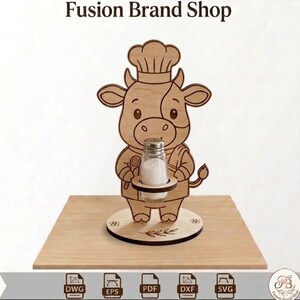May include: A wooden salt shaker holder shaped like a cartoon cow wearing a chef's hat and apron. The cow holds a glass salt shaker. The base is a round wooden platform with floral accents. The text "Fusion Brand Shop" is at the top.