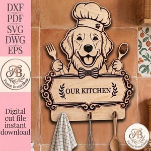 May include: A light-coloured wooden wall-mounted sign featuring a laser-engraved golden retriever wearing a chef hat and bowtie. The dog holds a fork and spoon. Below the dog is a plaque with the text OUR KITCHEN and three metal hooks for hanging.