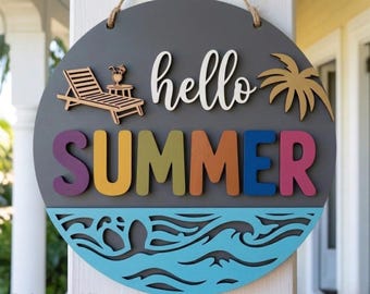 May include: A round, gray wooden sign with the words "hello SUMMER" in white and colorful letters. The sign features a wooden beach chair, a palm tree, and a blue wave design at the bottom. A rope is attached for hanging.