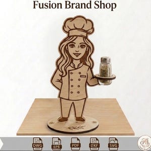 May include: Wooden chef figurine holding a spice jar. The figurine is light brown with engraved details, including a chef's hat and uniform. The base is round with a floral design and the text "Fusion Brand Shop".