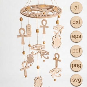 May include: A wooden mobile featuring Egyptian symbols like the Eye of Horus, ankhs, and scarabs. The mobile has a circular top with a sun design and is suspended by strings with gold beads. The text "Fusion Brand Shop" is at the bottom.