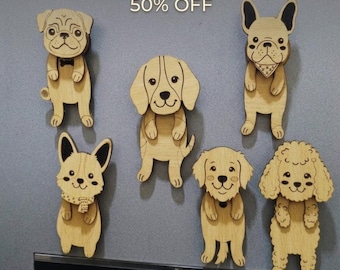 May include: A set of six wooden dog magnets in various breeds, including a pug, French bulldog, and poodle. Each magnet is light brown with black detailing and features a smiling dog face. The text "DOG LOVER'S MAGNET SET" is at the top.