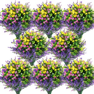 Peut inclure: Neuf bouquets de fleurs artificielles aux couleurs variées. Les fleurs présentent un feuillage violet, jaune, rose et vert. L'arrangement est dense et plein, avec une variété de textures et de formes. Les fleurs sont regroupées, créant un affichage vibrant et coloré.