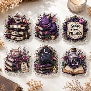 May include: A set of six decorative acrylic stickers featuring fantasy themes including a purple dragon on books, a black cat, floral arrangements, teacups, and potion bottles with text reading Just One More Chapter, Books Before Villains, and Plot Twist.