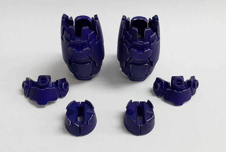 May include: A set of six dark purple plastic model kit components, including two large segmented leg armor pieces, two smaller shoulder or hip armor sections with circular connectors, and two small circular base or joint covers.